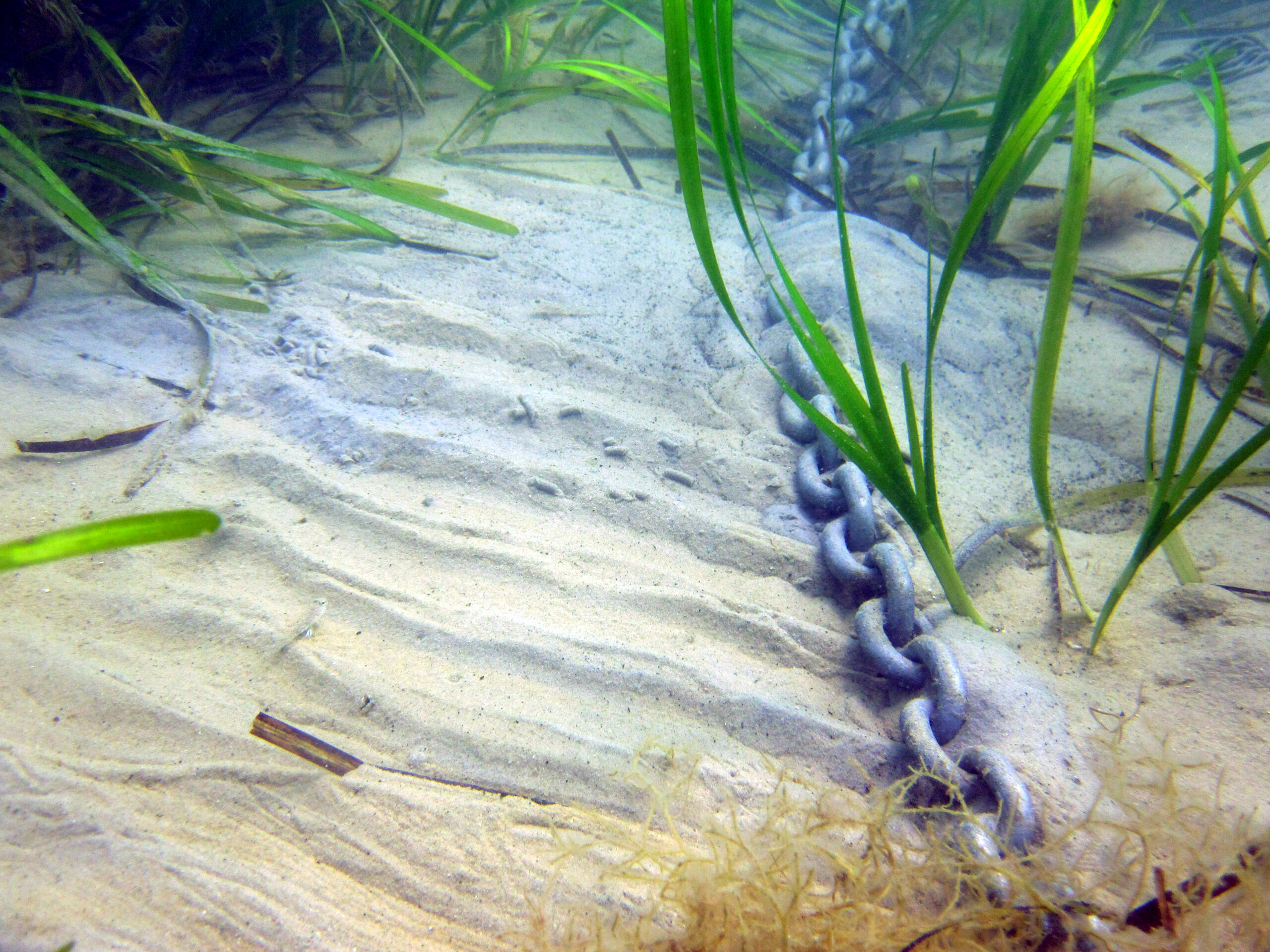 Anchor chain dragging along seabed.