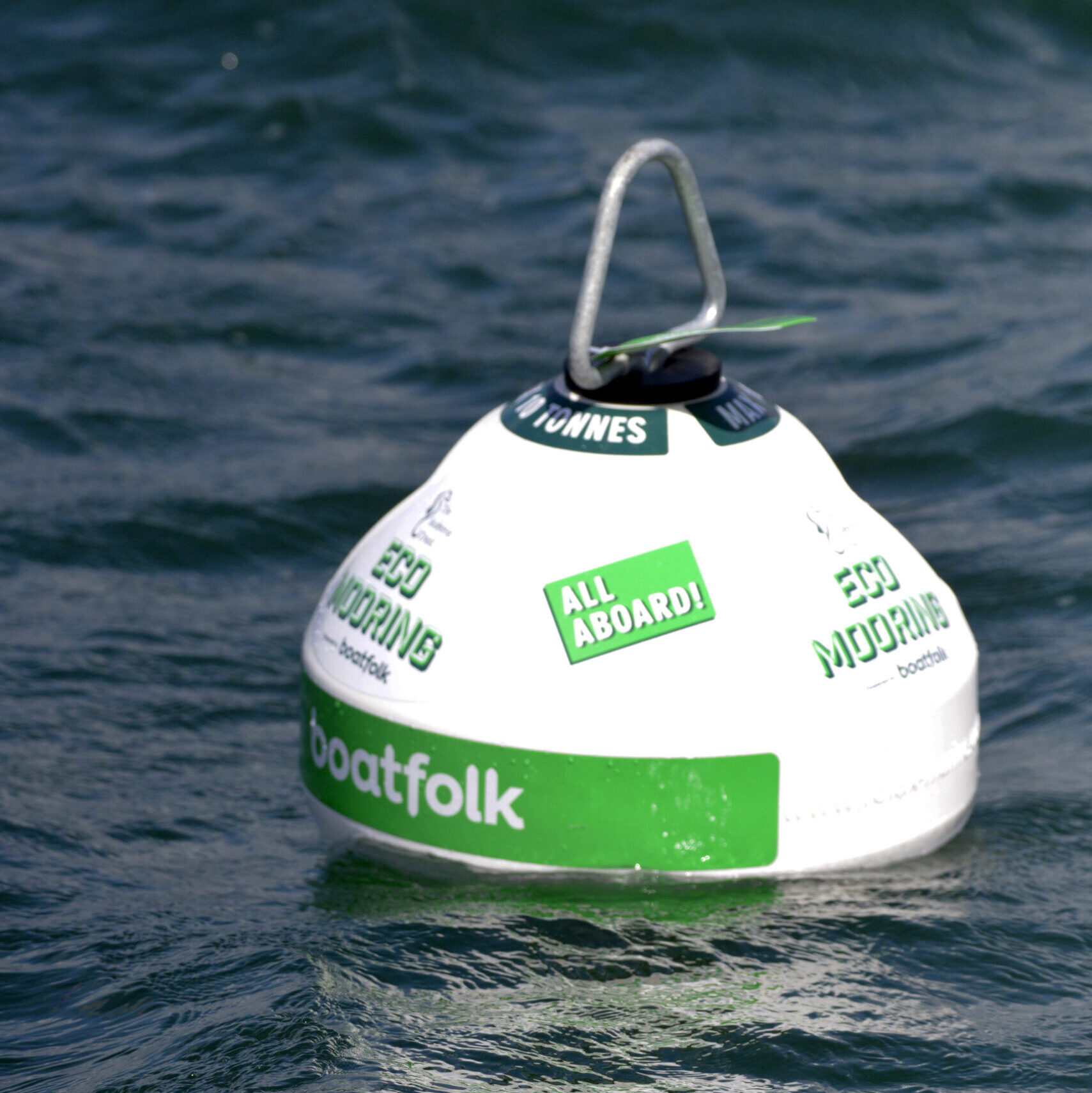A white and green eco-mooring on the sea.